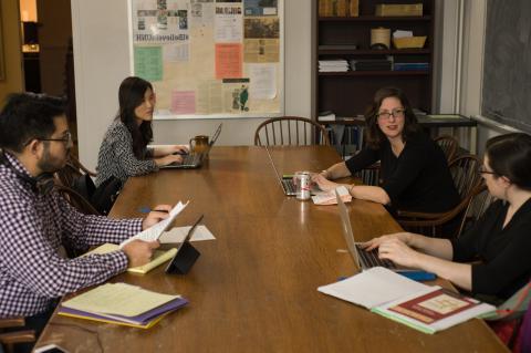 Discussion around a table with reference materials