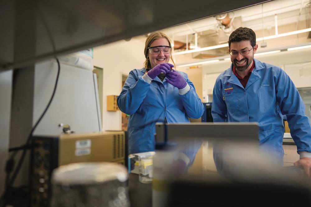 UNH researcher Jeffrey Halpern and student work in a lab